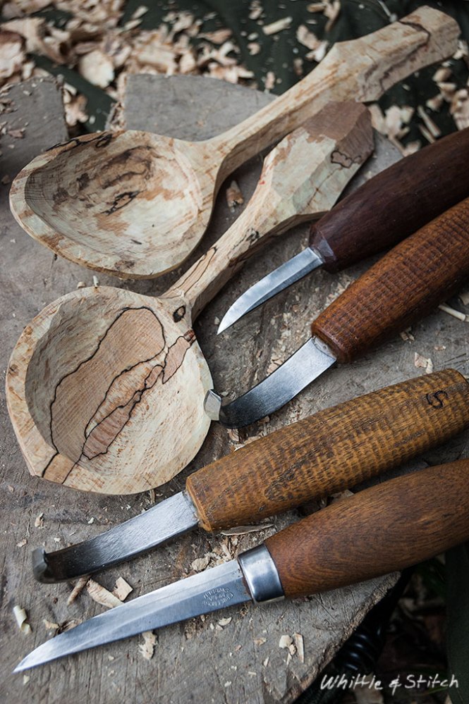 Spoon carving knives and hand carved spoon s in spalted Beech sitting on wooden block. Colour Portrait. © P. Maton 2015 whittleandstitch.net
