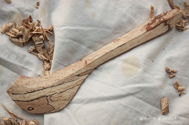 Spalted Beech wood hand carved spatula by Peter Maton lying on cloth with wood shavings. Colour Landscape. © P. Maton 2014 whittleandstitch.net